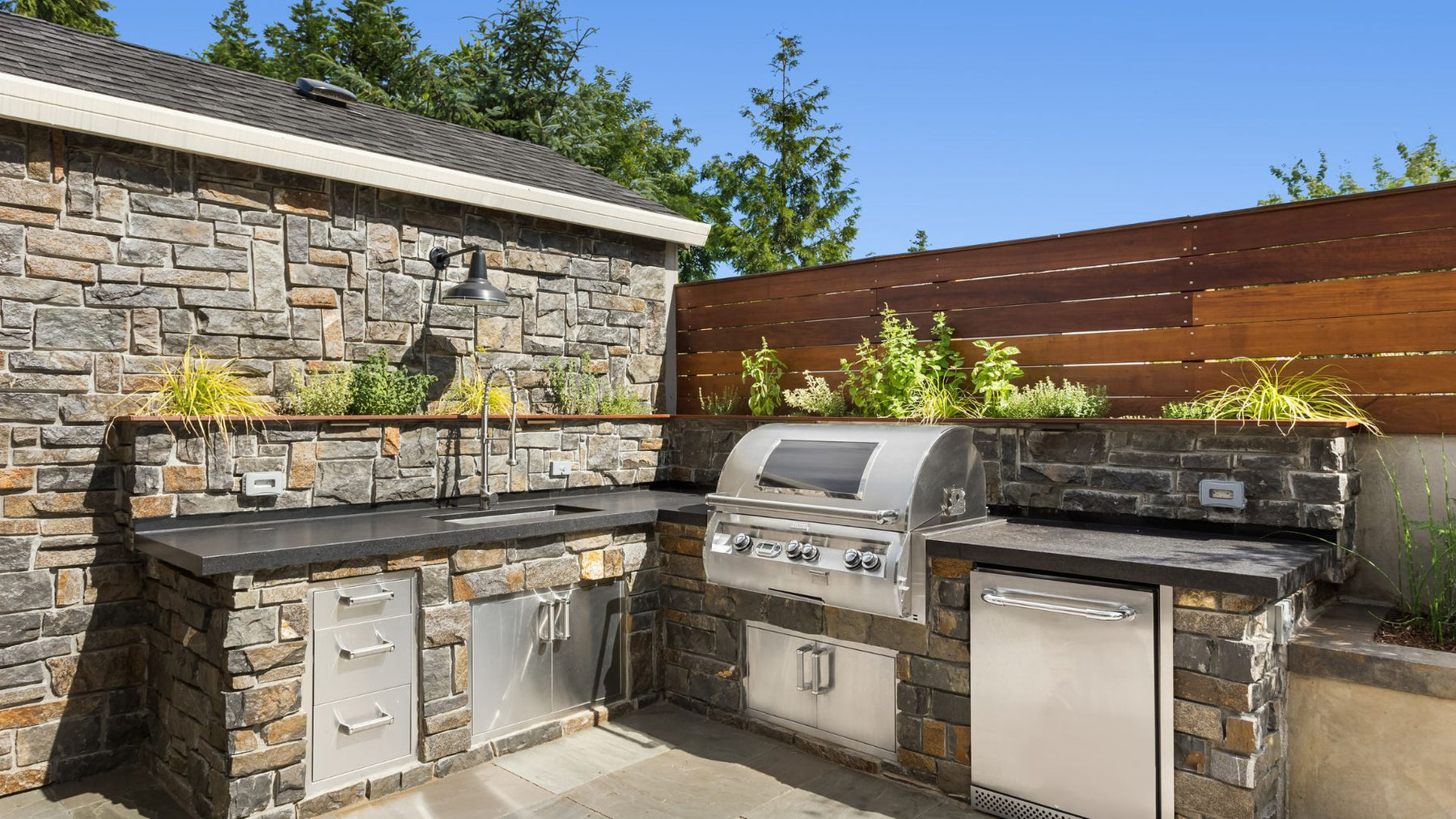 brick and steel outdoor kitchen set up