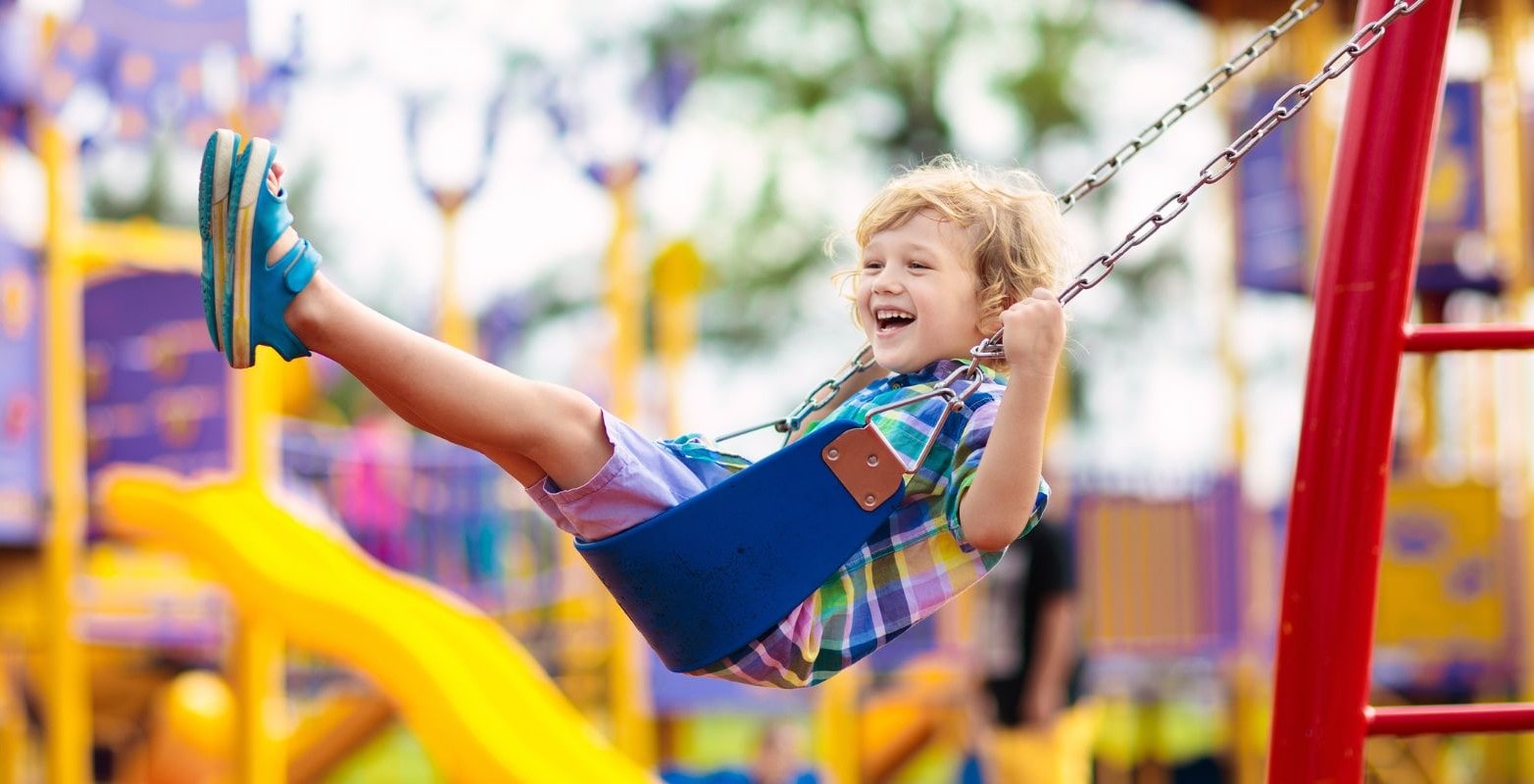 child happily enjoying the swing