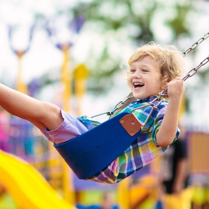 child happily enjoying the swing