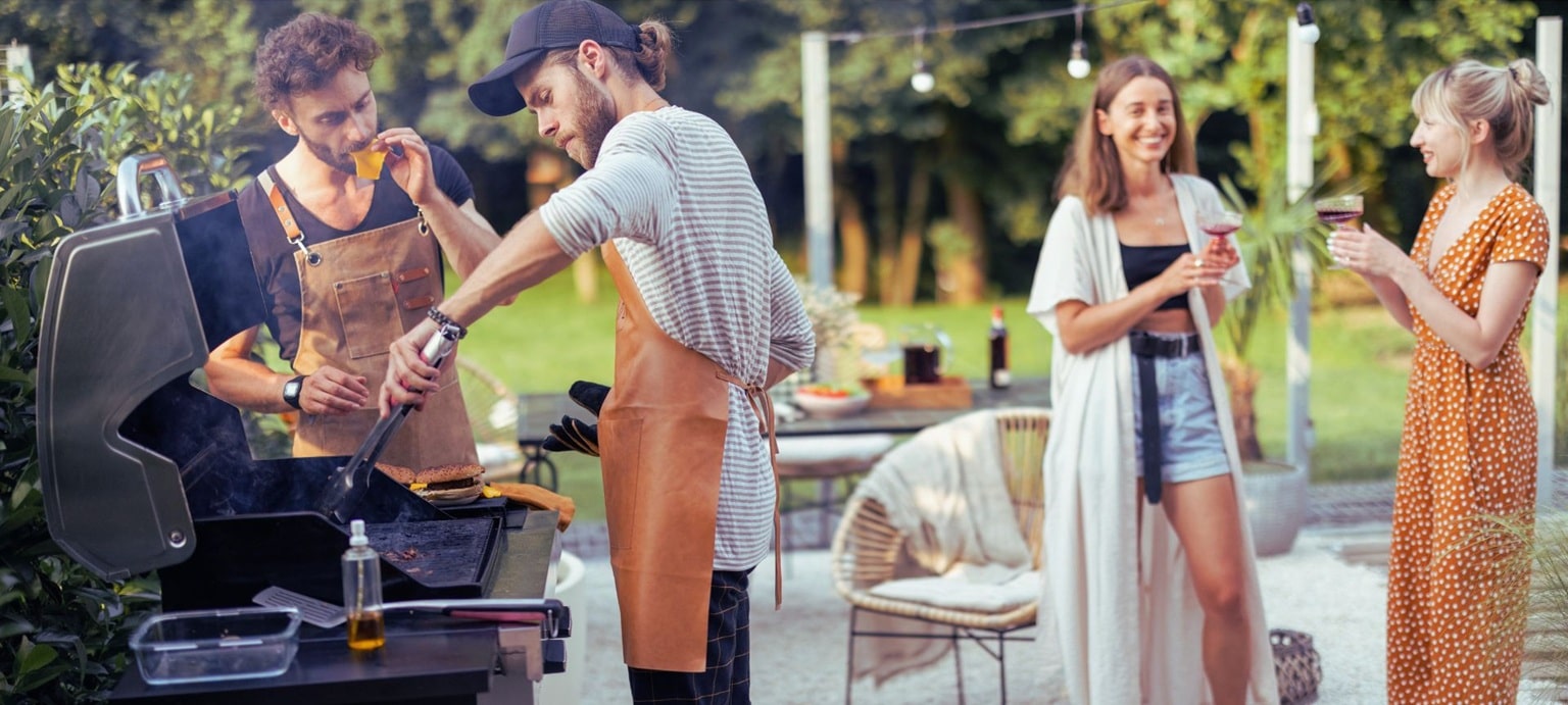 friends cooking and chatting at a backyard